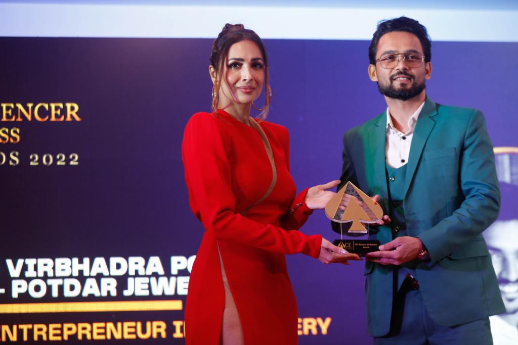 Founder receiving an award from Malaika Arora at the 2022 Awards
